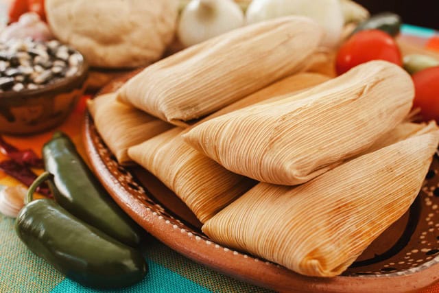 A closeup of a plate of tamales.