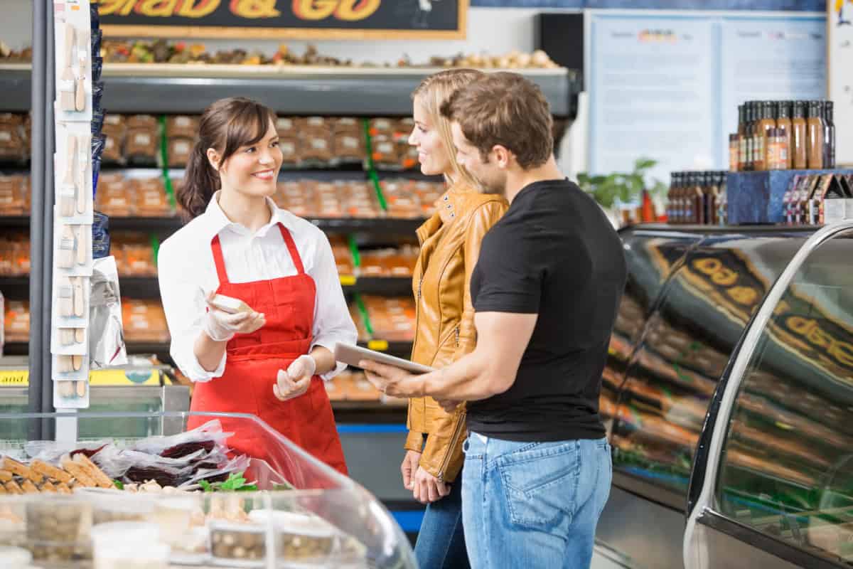 A staff member assists a couple with their questions
